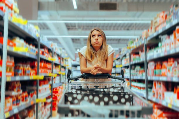 Customer comparing products while shopping in a large retail store