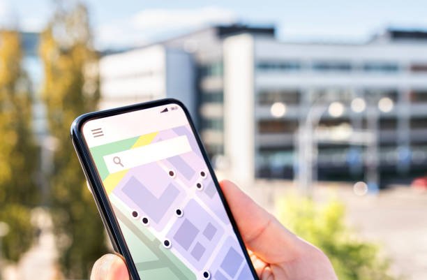A map app on a smartphone showing a pin just outside the city center with public transport lines leading into it