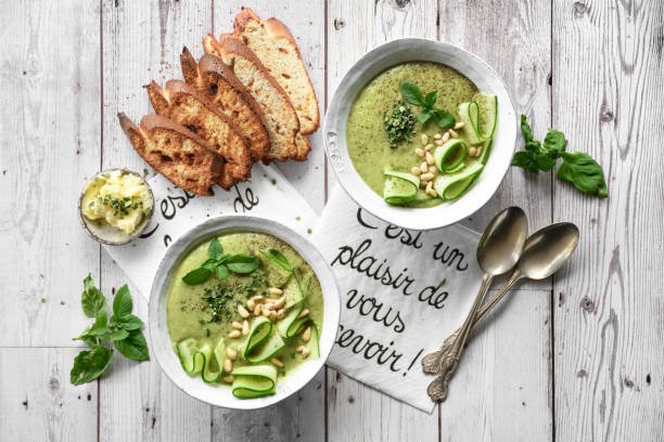 Fresh and Easy Summer Meals: Two bowls of chilled cucumber soup with garnishes and bread.