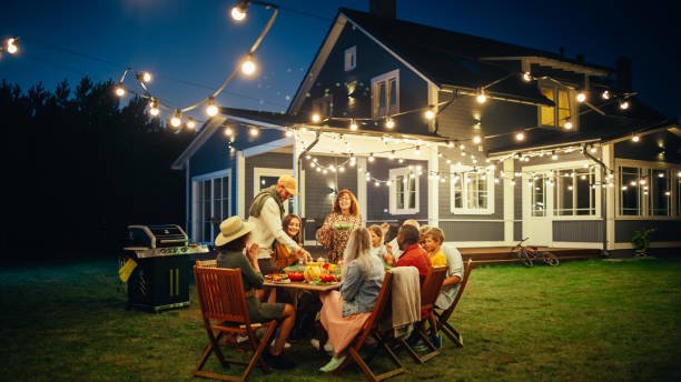 Group of diverse friends enjoying an outdoor dinner party.