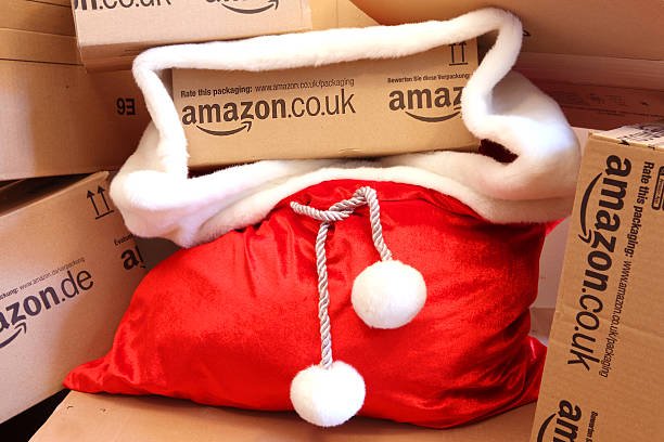 A red Santa sack full of affordable Amazon gifts delivered in shipping boxes, ready for the holidays.