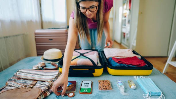 Am women is packing her things after searching Affordable Hotels for Travelers.