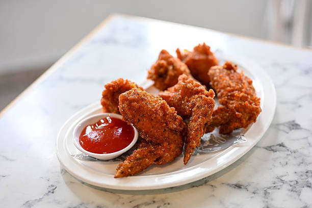 Close up Fried chicken wings and sauce chili Thai street food quick appetizers