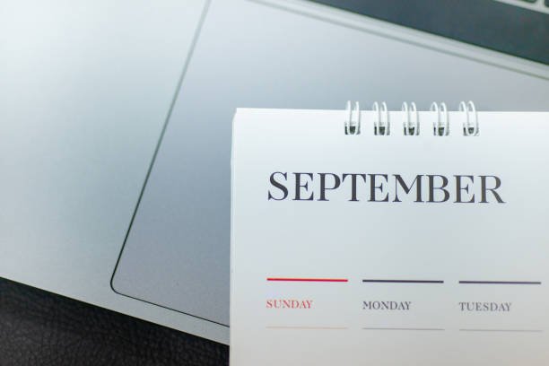Blurred calendar in planning work concept. A September desk calendar resting on a laptop, symbolizing a fresh start to get finances back on track this month.
