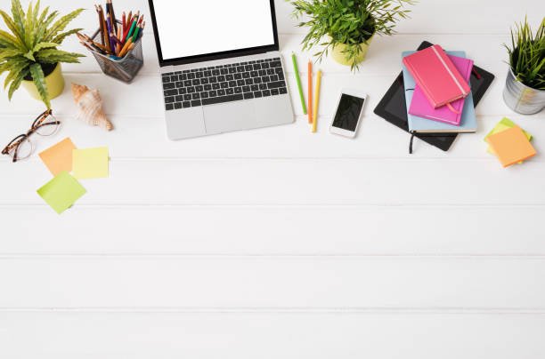 Creative person's desk from above Set New Goals Use Modern Tools