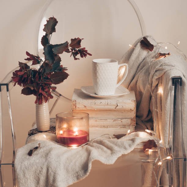 A cozy fall image featuring an Elite Wellness Routine setup, including an affordable essential oil diffuser and a soft blanket.